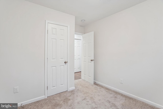 unfurnished bedroom with carpet flooring and baseboards