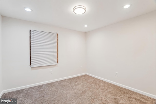 empty room with carpet flooring, recessed lighting, and baseboards