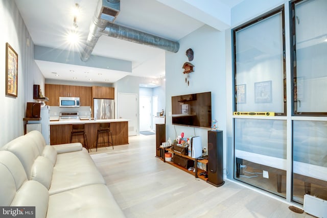 living area featuring visible vents and light wood finished floors