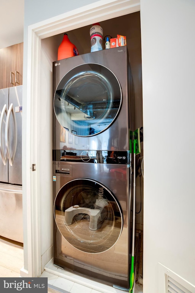 washroom with laundry area and stacked washing maching and dryer