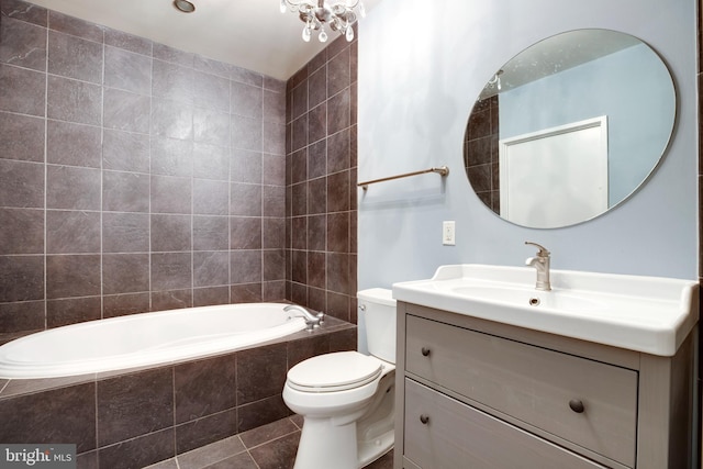 full bath with a relaxing tiled tub, toilet, vanity, and tile patterned flooring