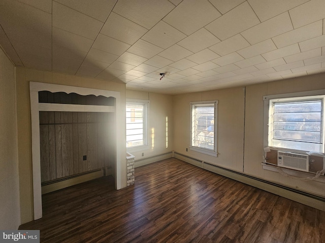 unfurnished living room featuring baseboard heating, cooling unit, a baseboard radiator, and wood finished floors