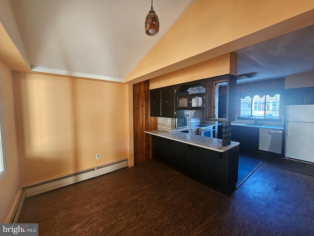 kitchen with white appliances, dark wood finished floors, a sink, vaulted ceiling, and a baseboard heating unit