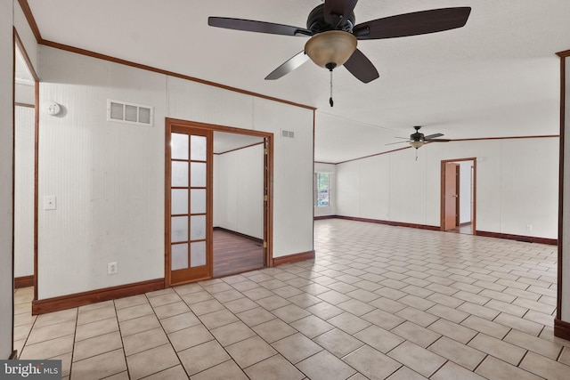 spare room featuring light tile patterned flooring, visible vents, crown molding, and a ceiling fan