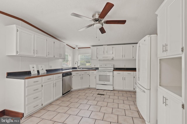 kitchen featuring under cabinet range hood, dark countertops, white appliances, white cabinets, and ceiling fan