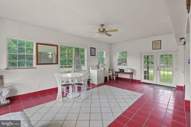 dining room with tile patterned flooring, french doors, a ceiling fan, and a wealth of natural light