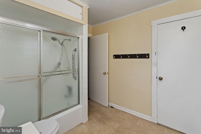 bathroom featuring crown molding, toilet, baseboards, and shower / bath combination with glass door