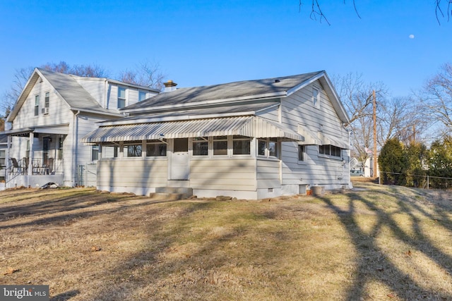 view of side of home with a lawn