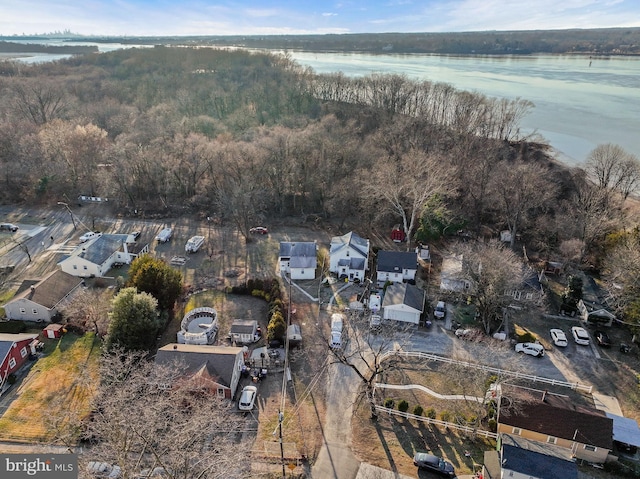 aerial view with a forest view and a water view