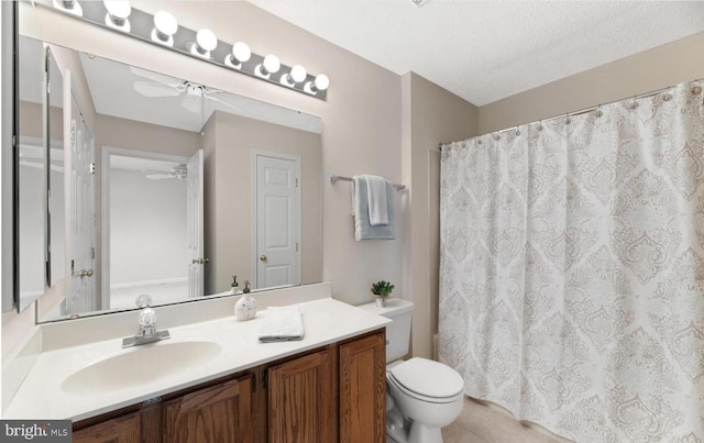 bathroom with toilet, vanity, tile patterned floors, a textured ceiling, and a ceiling fan