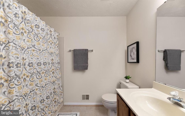 bathroom featuring tile patterned floors, visible vents, toilet, a textured ceiling, and vanity