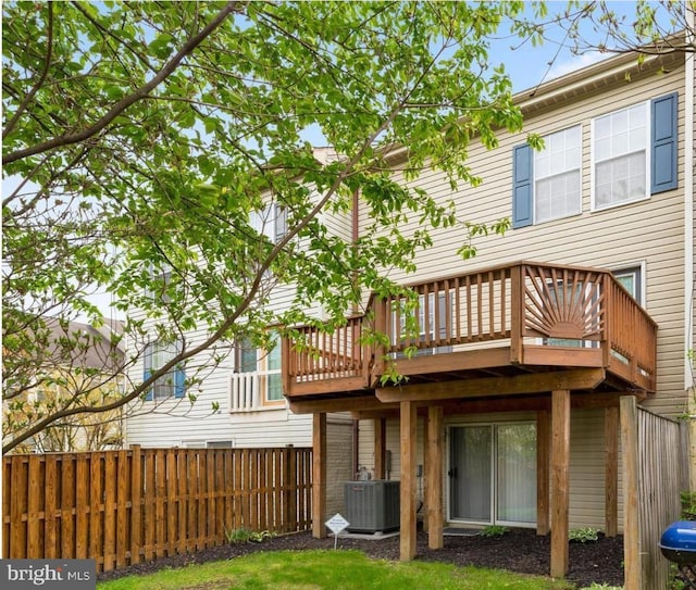 back of property featuring cooling unit, a wooden deck, and fence