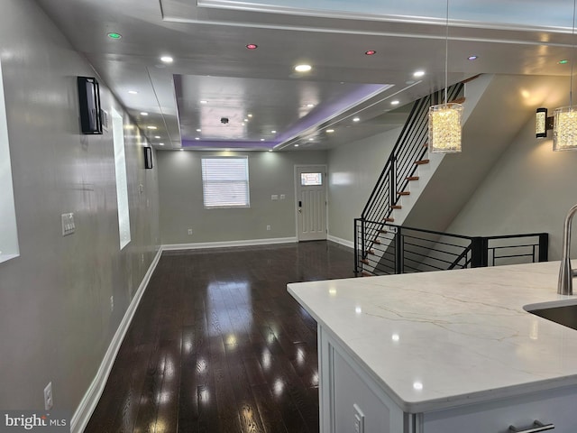 interior space featuring recessed lighting, baseboards, and dark wood finished floors