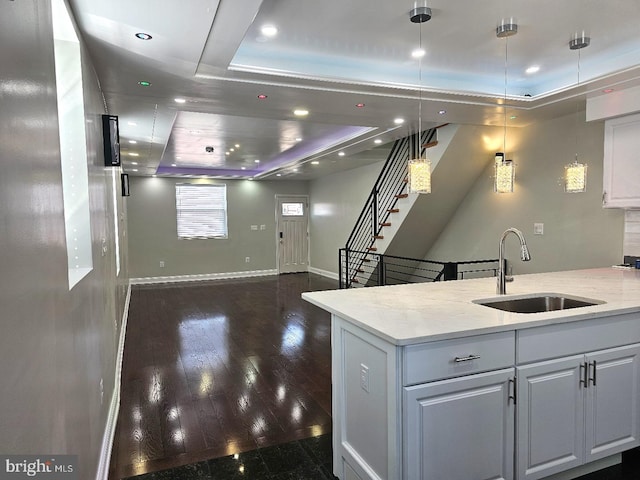 kitchen featuring baseboards, recessed lighting, dark wood-style flooring, a sink, and white cabinets