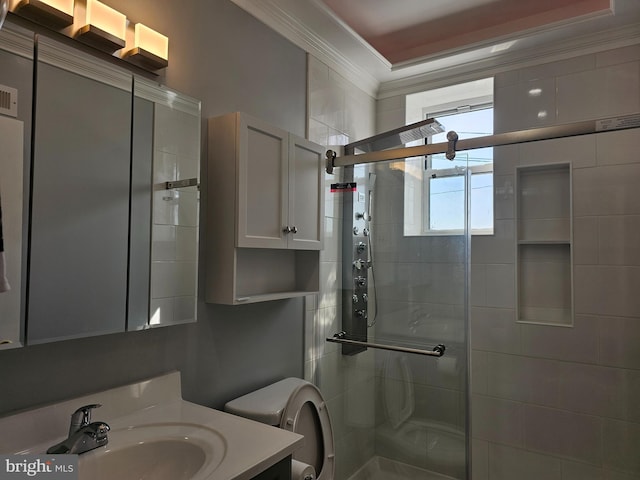 full bath with vanity, a shower stall, crown molding, and toilet