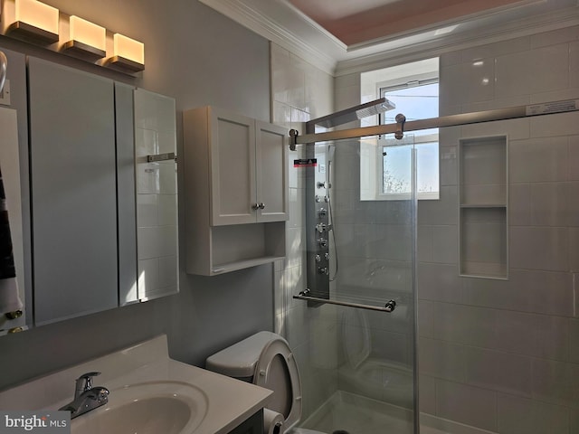 full bathroom featuring toilet, a stall shower, vanity, and ornamental molding