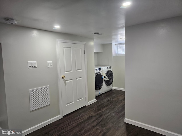 laundry area with independent washer and dryer, laundry area, visible vents, and dark wood-style flooring