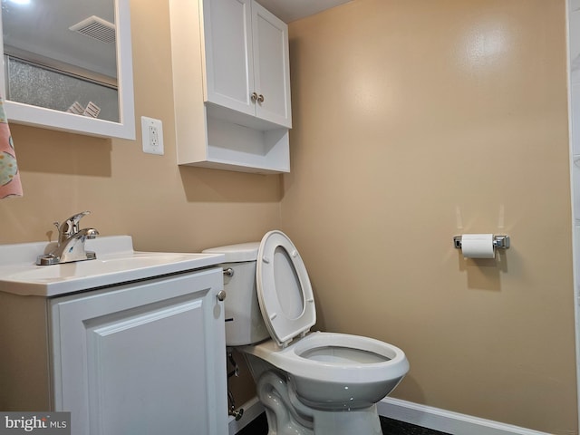 bathroom featuring visible vents, baseboards, toilet, and vanity