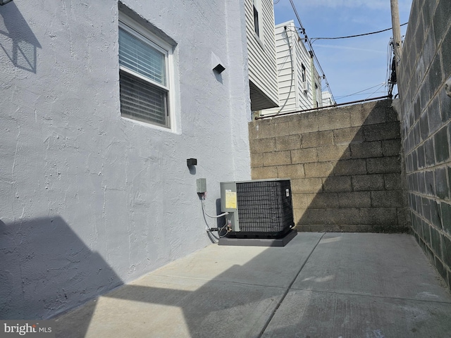 exterior space featuring cooling unit and fence