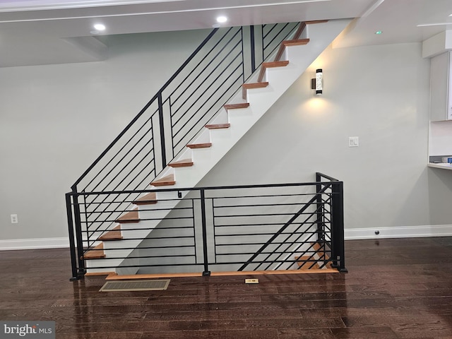 stairs with recessed lighting, baseboards, and wood finished floors