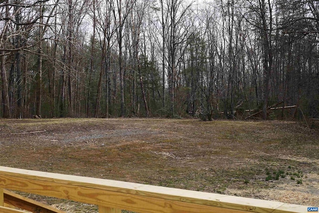 view of yard featuring a forest view