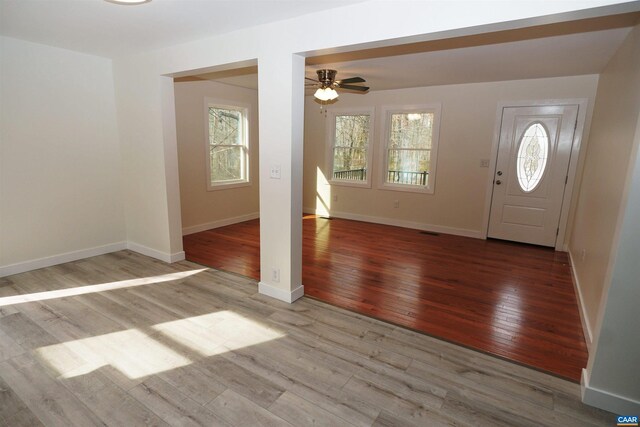 foyer featuring visible vents, wood finished floors, baseboards, and ceiling fan