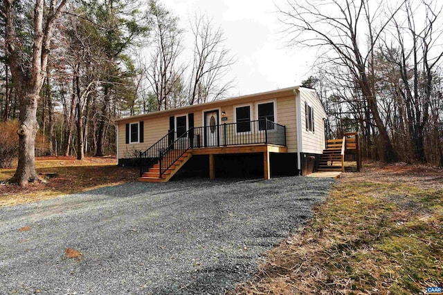 manufactured / mobile home featuring stairway and a deck