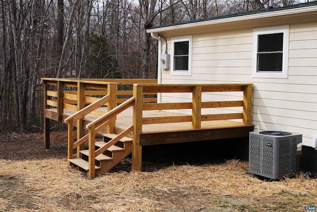 deck featuring central air condition unit and stairway