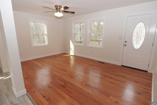 entryway with light wood-type flooring, visible vents, and plenty of natural light