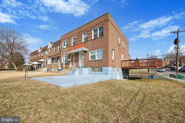 view of front facade with a front yard and brick siding