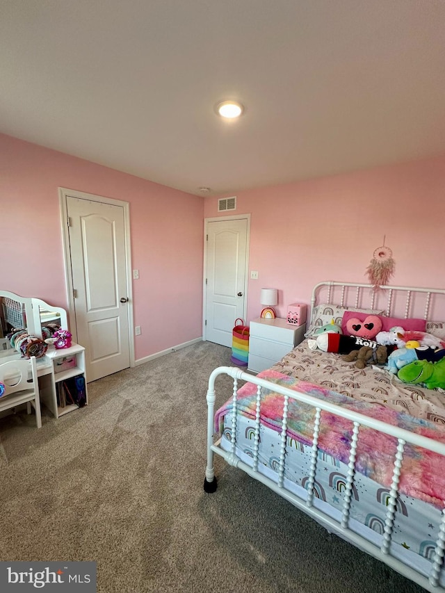 carpeted bedroom featuring visible vents