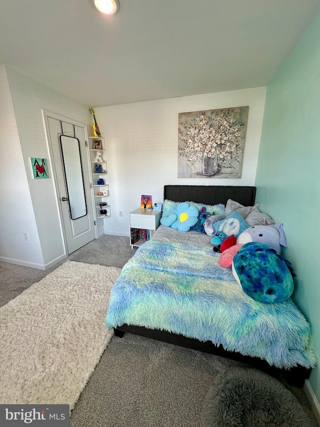 bedroom featuring carpet flooring and baseboards