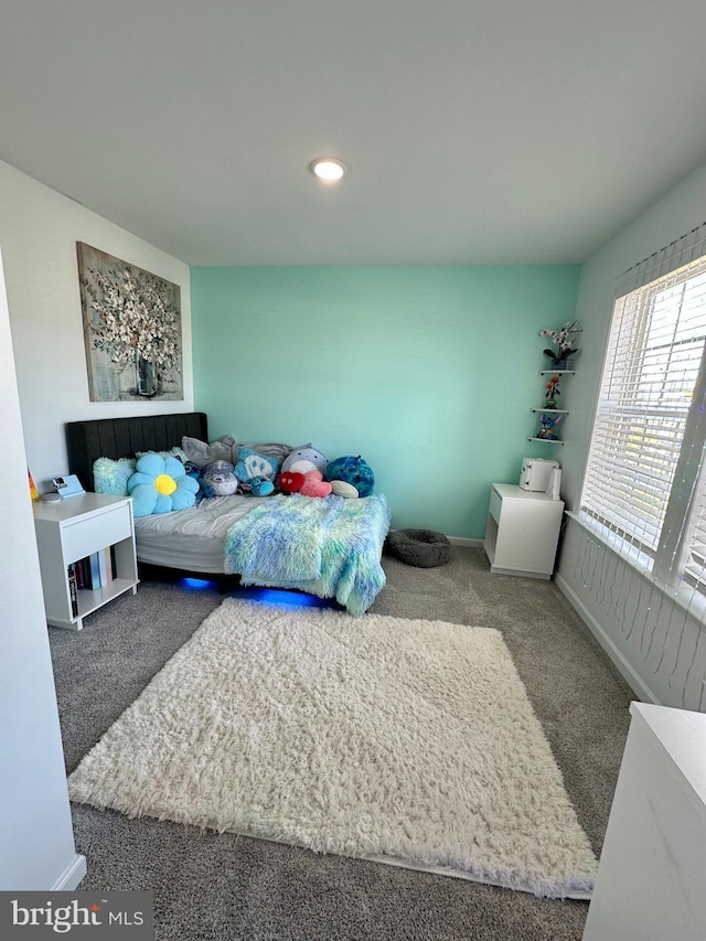 bedroom with carpet and baseboards