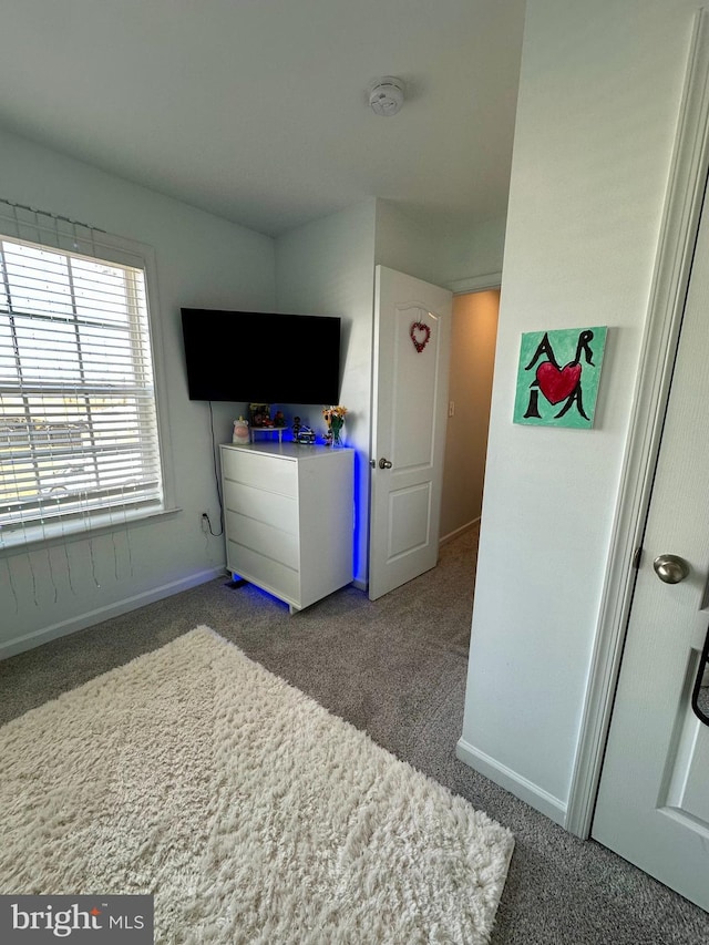 carpeted bedroom with baseboards