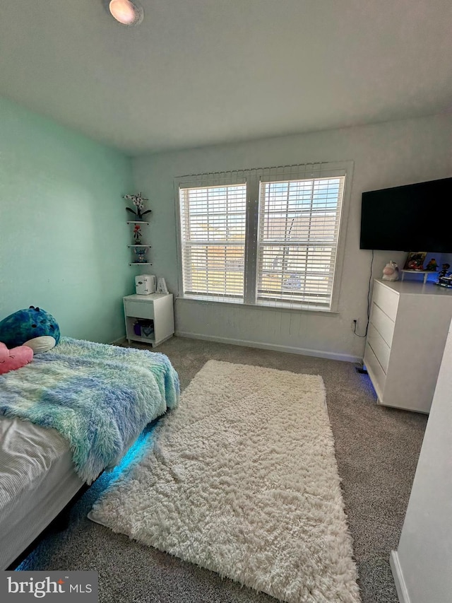 carpeted bedroom featuring baseboards