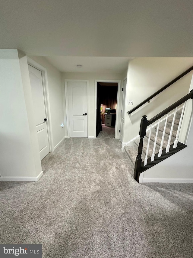 interior space featuring baseboards and carpet floors