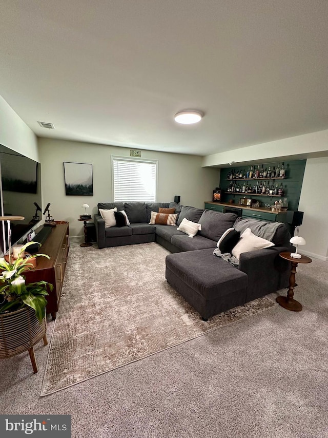 living area featuring visible vents and carpet flooring