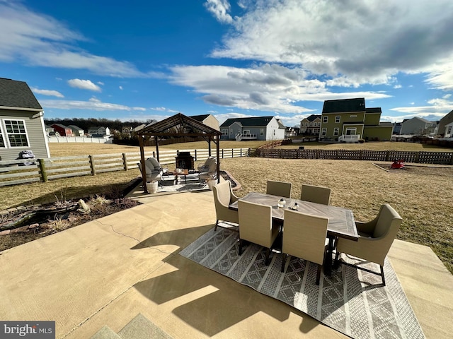 view of patio featuring a gazebo, outdoor dining area, a residential view, and fence