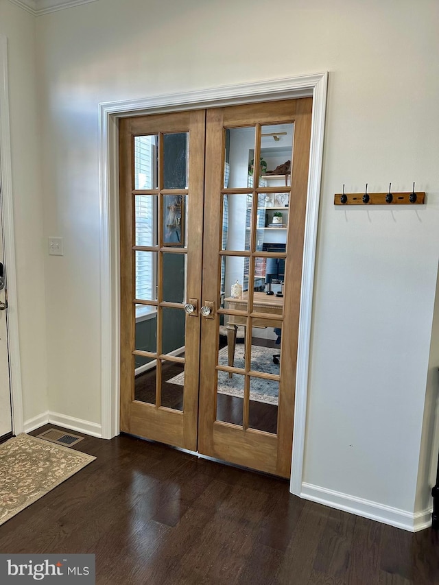 entryway featuring french doors, baseboards, and dark wood-type flooring