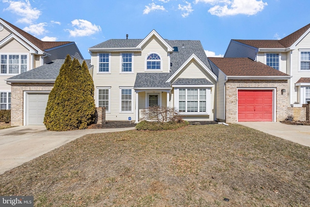 view of front facade with concrete driveway, an attached garage, and roof with shingles