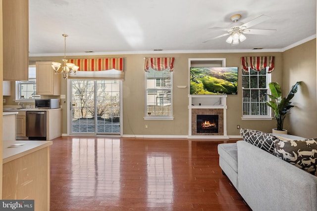 living area featuring ornamental molding, a fireplace, and hardwood / wood-style flooring