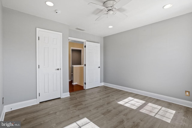 unfurnished bedroom featuring recessed lighting, baseboards, and wood finished floors