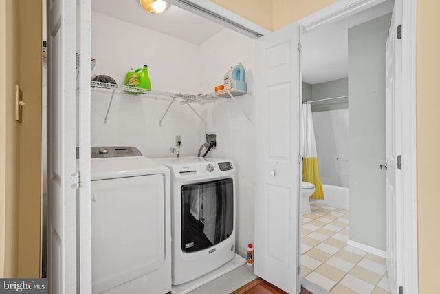 laundry area featuring separate washer and dryer and laundry area