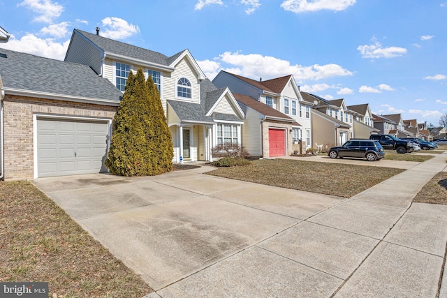 view of front facade featuring an attached garage, a residential view, driveway, and roof with shingles