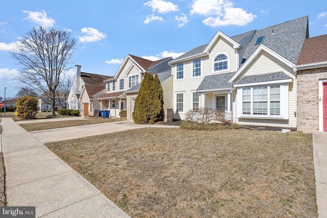 view of front of house with a shingled roof, a front lawn, a residential view, concrete driveway, and a garage