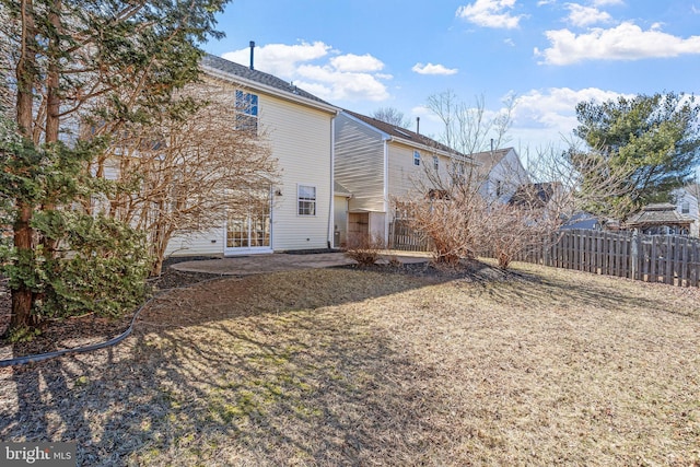 back of house featuring a patio area and fence