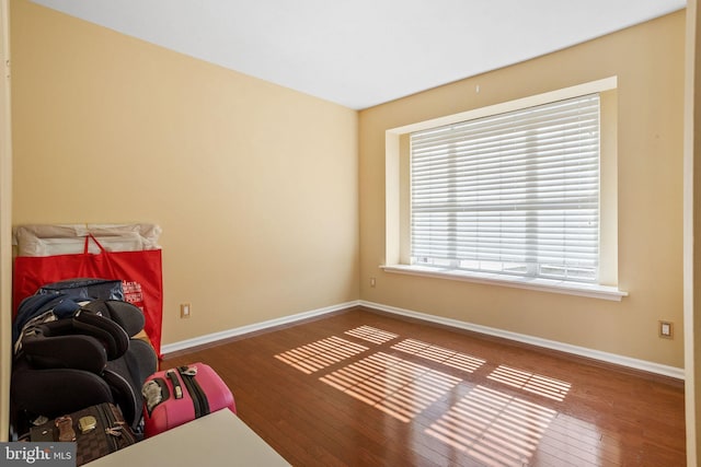 sitting room featuring baseboards and hardwood / wood-style flooring