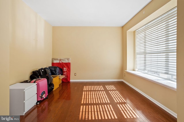 spare room with wood finished floors and baseboards