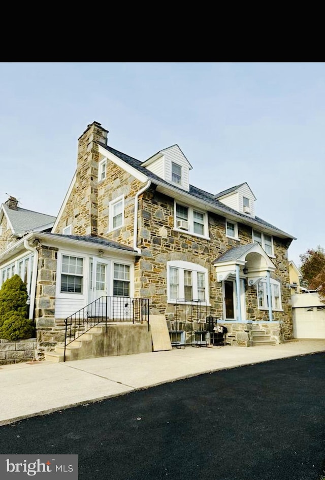 view of property featuring stone siding