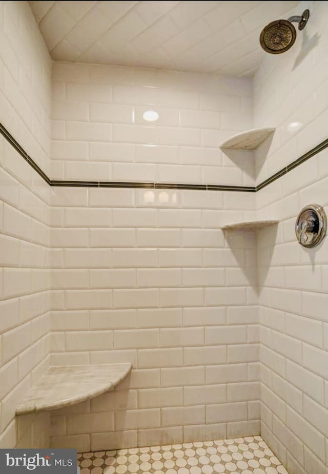 bathroom with a tile shower